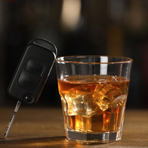 glass of alcohol and keys